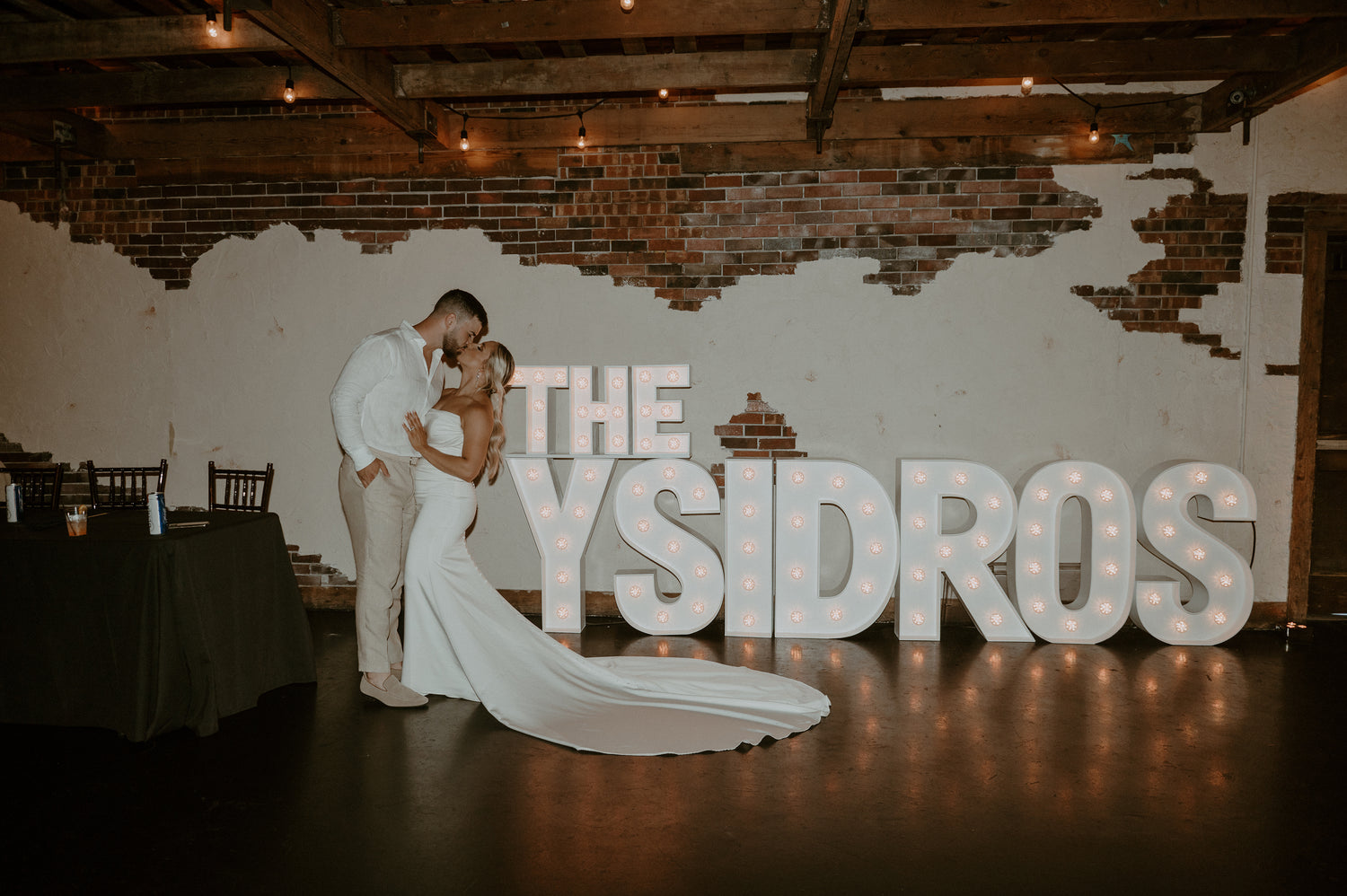 Charming Wichita, KS wedding scene featuring beautifully illuminated marquee letters, adding a touch of personalized magic to the celebration backdrop.